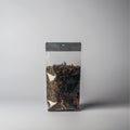 Arabianyte Koffie coffee beans in a glass jar with a scoop, showcasing the rich roasted coffee for brewing.